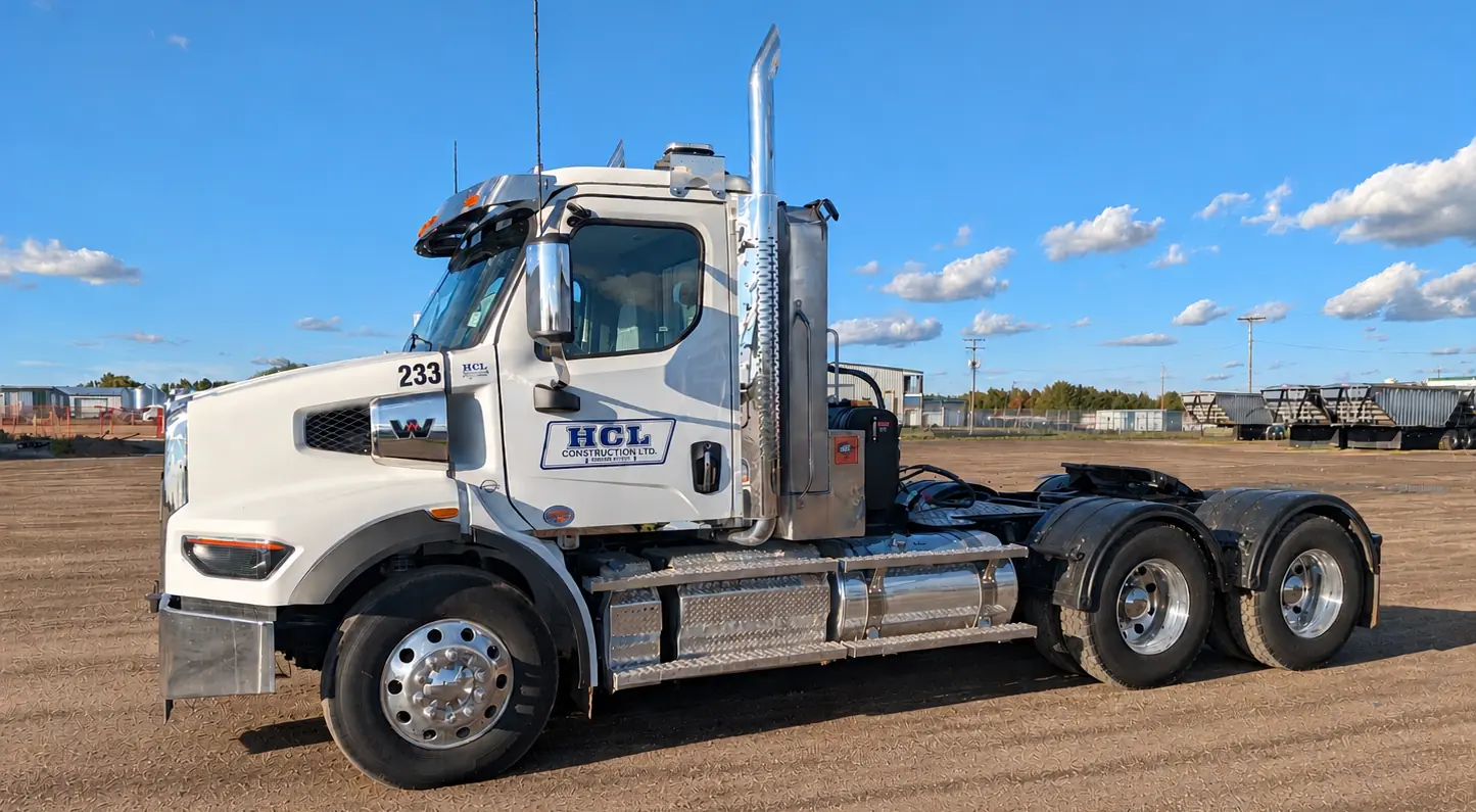 White Western Star day cab tractor on a gravel lot