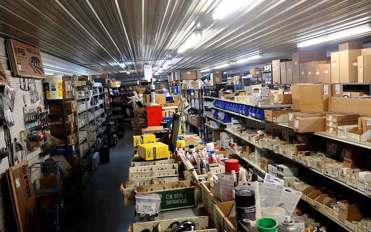 Parts room with shelving stocked with boxed truck and trailer parts, seals and bearings